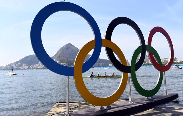 Rowers are seen through the Olympic rings as seen from Copacabana Beach. Mandatory Credit: Jack Gruber-USA TODAY Sports