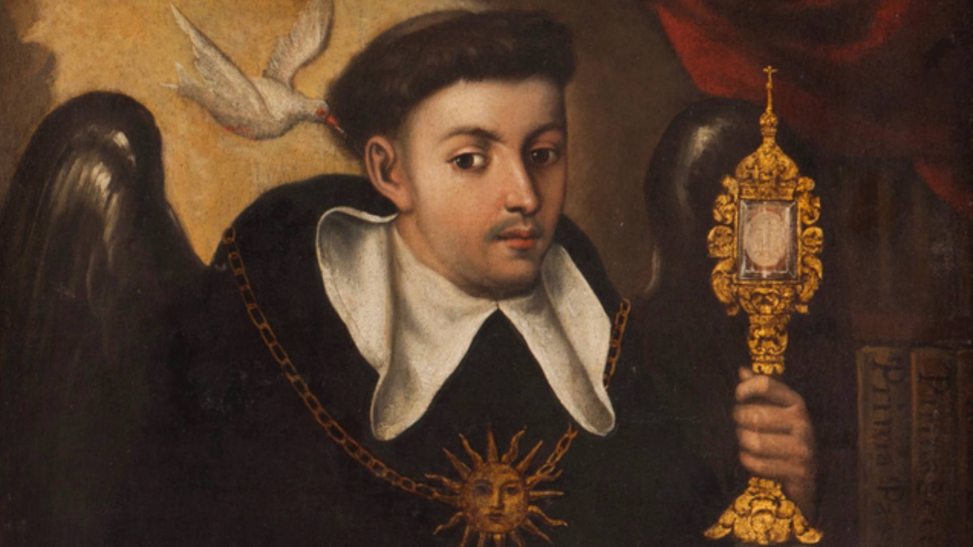 imagem de São Tomás de Aquino segurando um ostensório. E ao seu lado uma pomba próximo ao seu ouvido direito