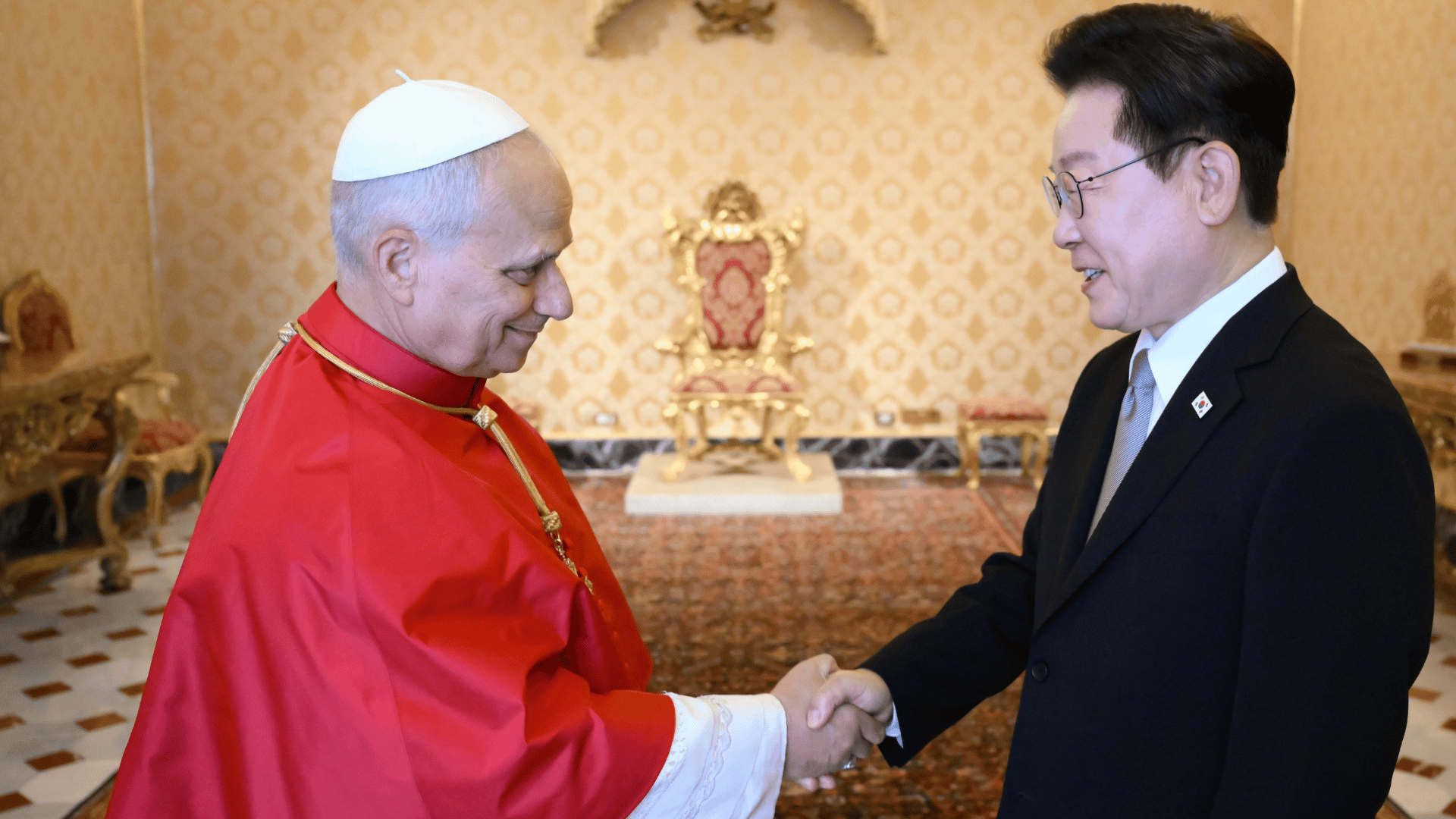 O Papa Leão XIV aparece com a tradicional moseta vermelha e aperta as mãos do presidente da Coreia do Sul