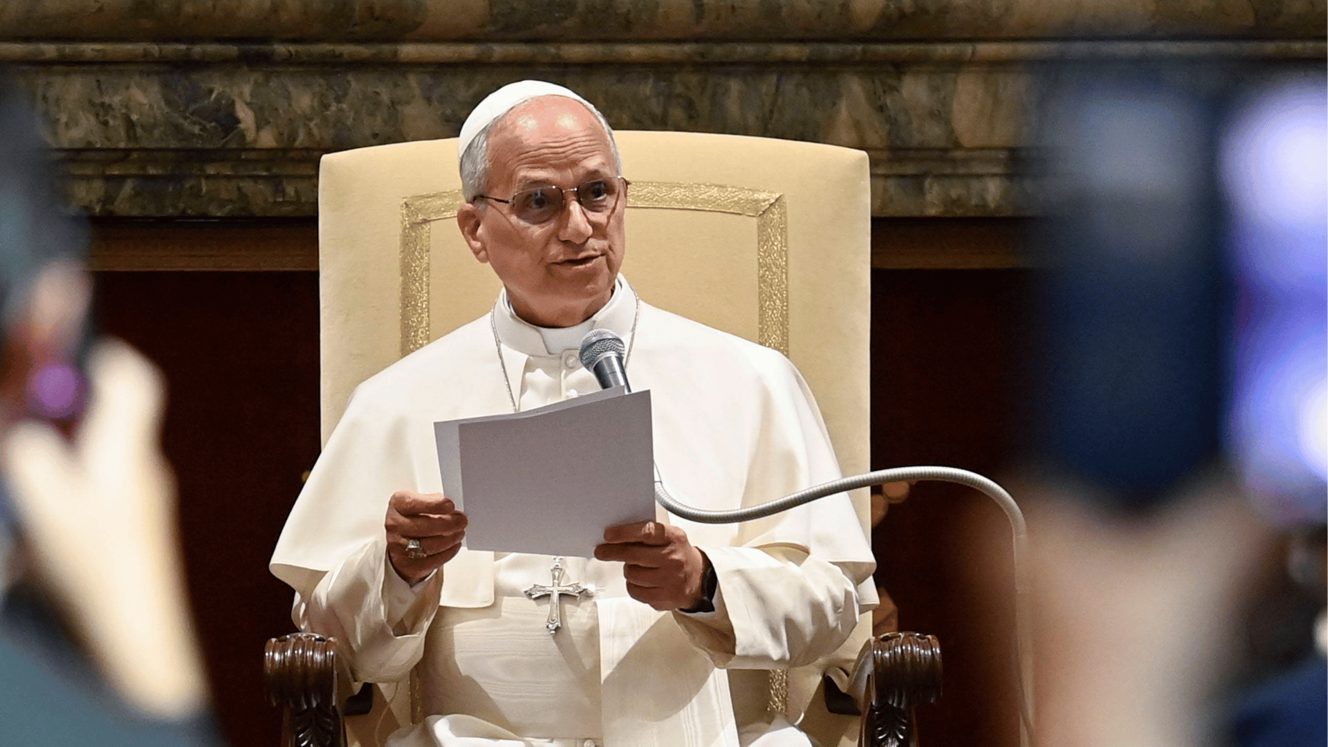 Sentado, Papa Leão XIV fala ao microfone durante audiência no Vaticano.