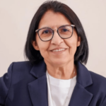 A imagem mostra a irmã Maria do Disterro com blusa branca e blazer azul