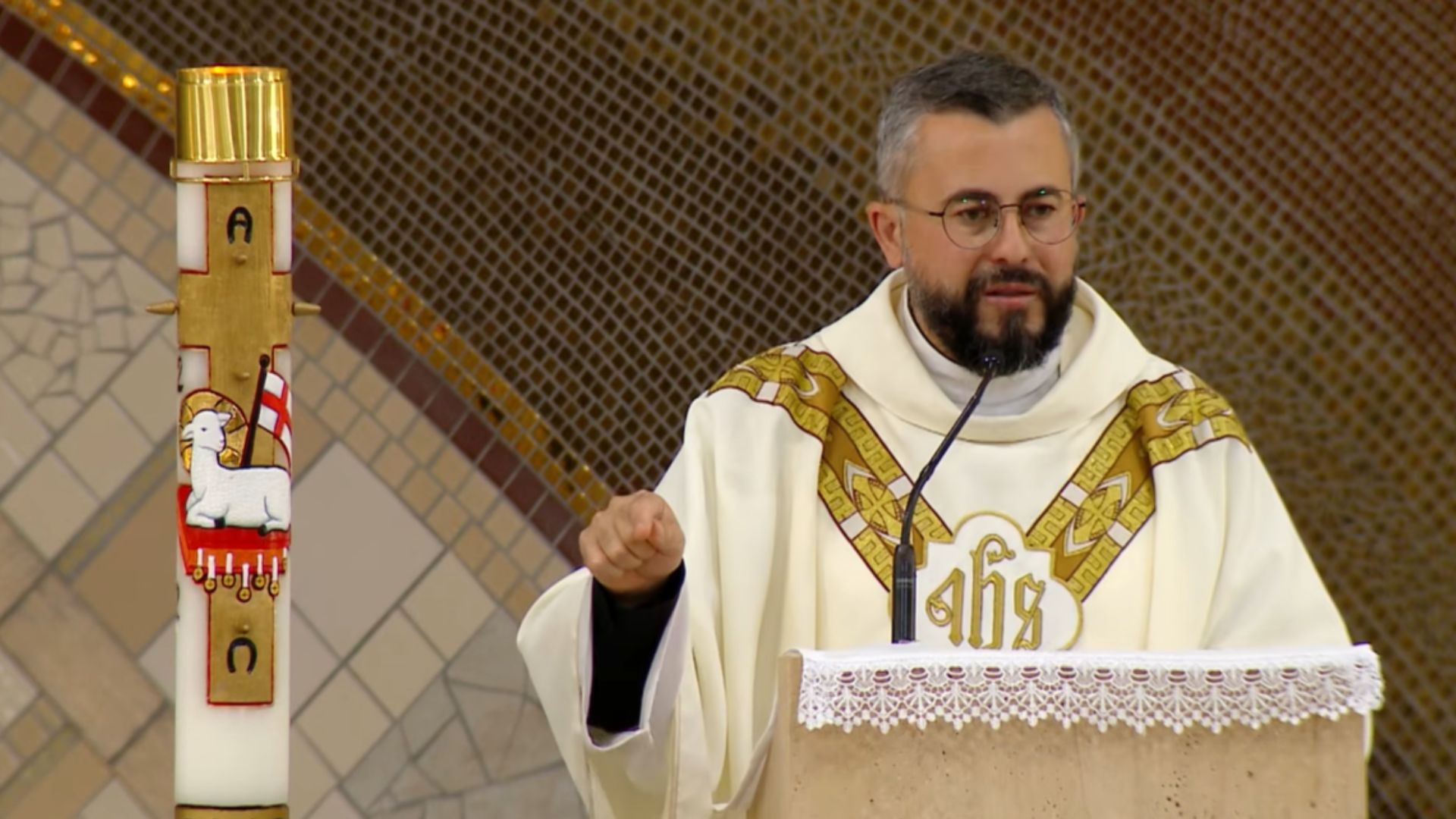 Sacerdote utilizando veste liturgica durante a Santa missa. Tema: "A visita de Maria que comunica Jesus"