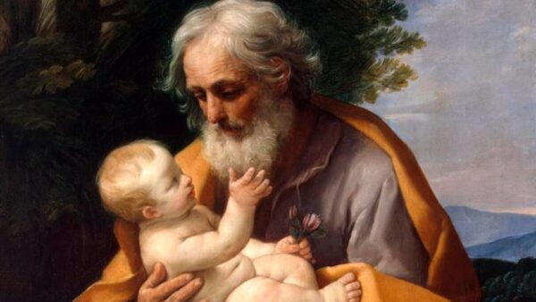 Uma pintura clássica retrata São José, barbudo e com expressão terna, segurando o Menino Jesus nu, que estende a mão para uma flor.