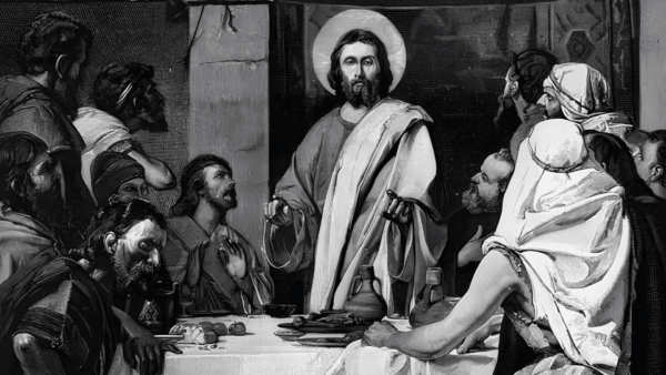 Ilustração a preto e branco que retrata Jesus Cristo ao centro, com uma auréola luminosa, de pé e a gesticular com as mãos enquanto ensina. Ele está rodeado por um grupo de pessoas atentas, com vestes da época, que o ouvem atentamente ao redor de uma mesa com jarros e alguns alimentos. A obra tem uma iluminação dramática que destaca a figura de Jesus em contraste com as sombras do ambiente.